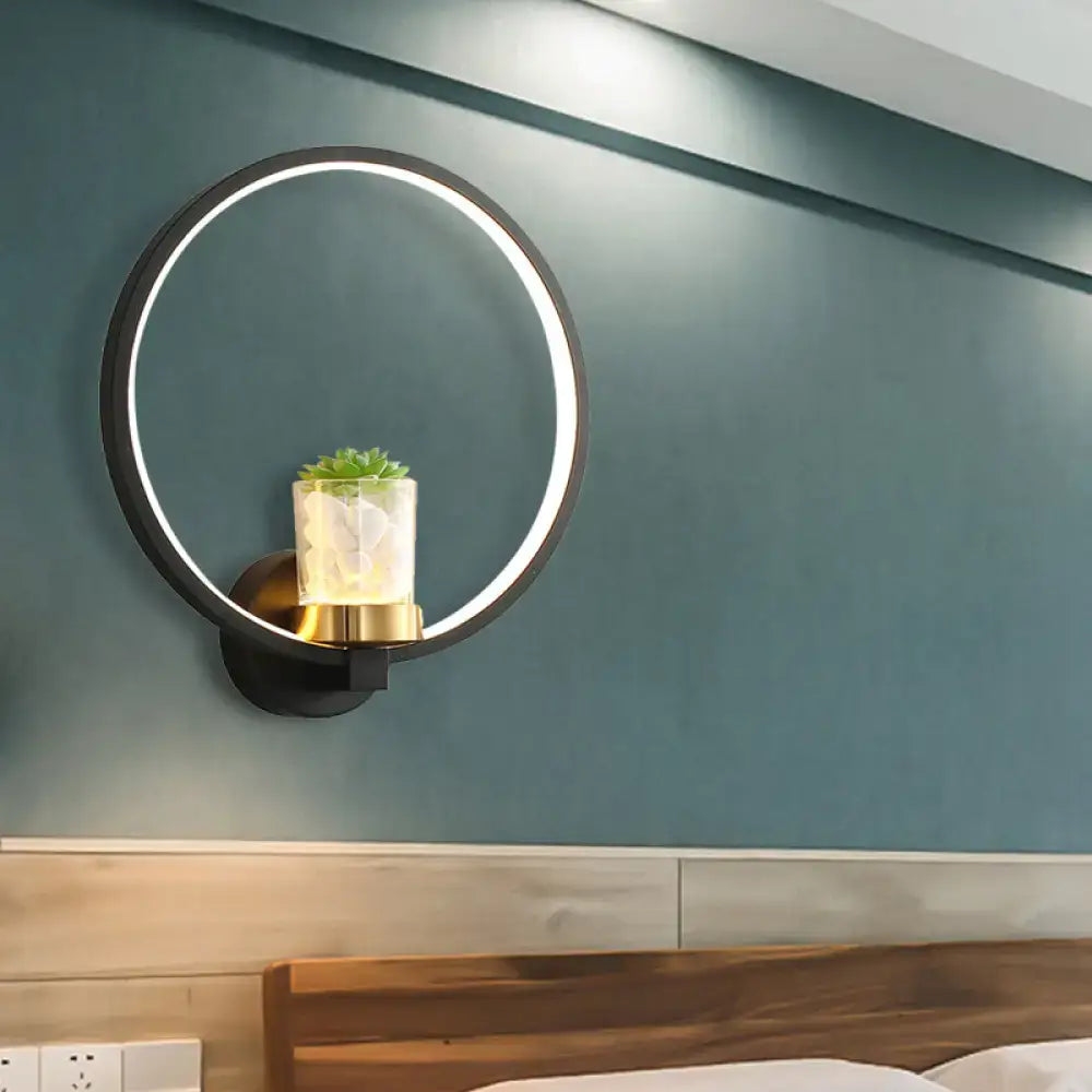 Decorbites black circular wall sconce with plant vase and gold base on teal wall on Tampa Home & Garden Store