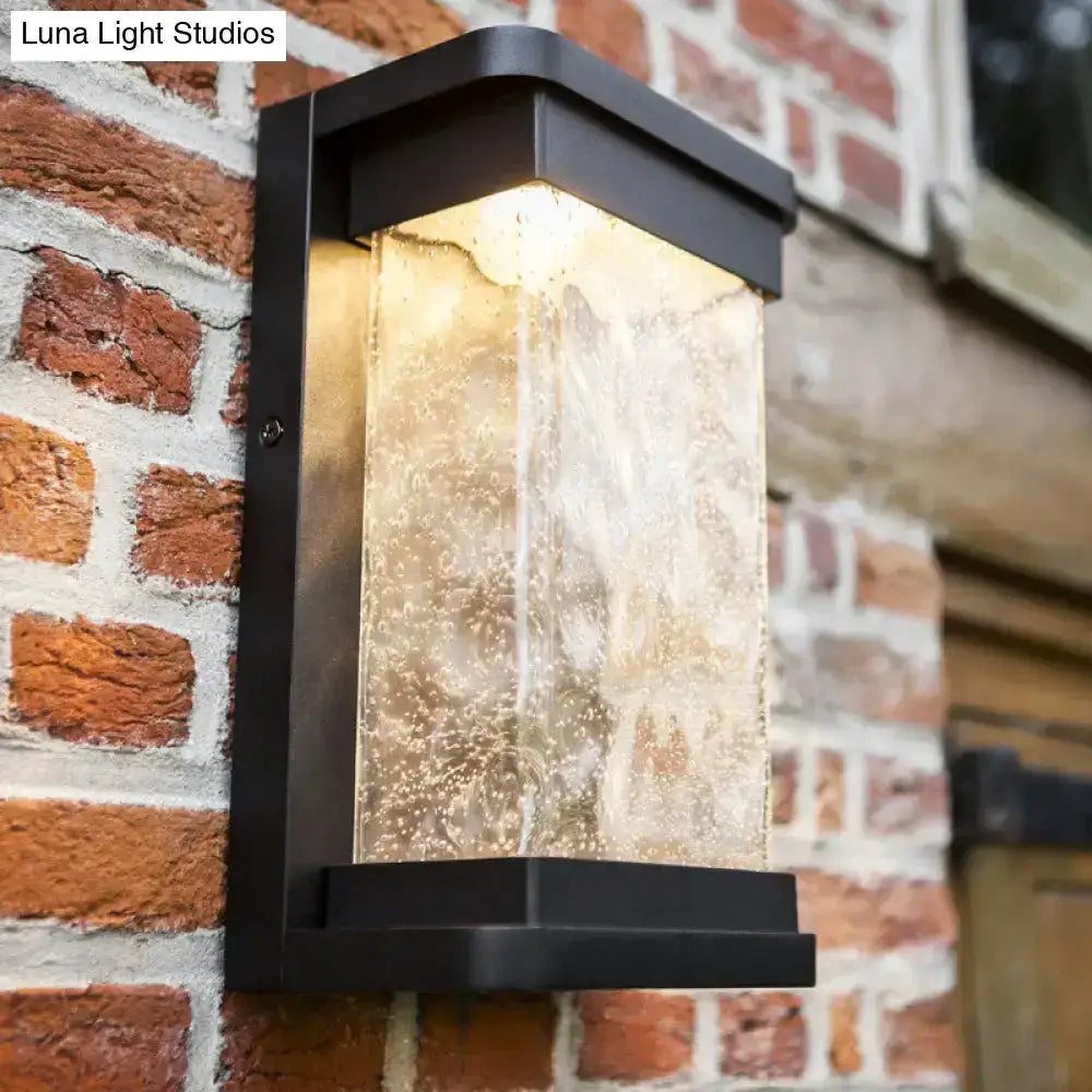Modern black LED outdoor wall sconce by Decorbites with rippled glass cylinder on Tampa Home & Garden Store