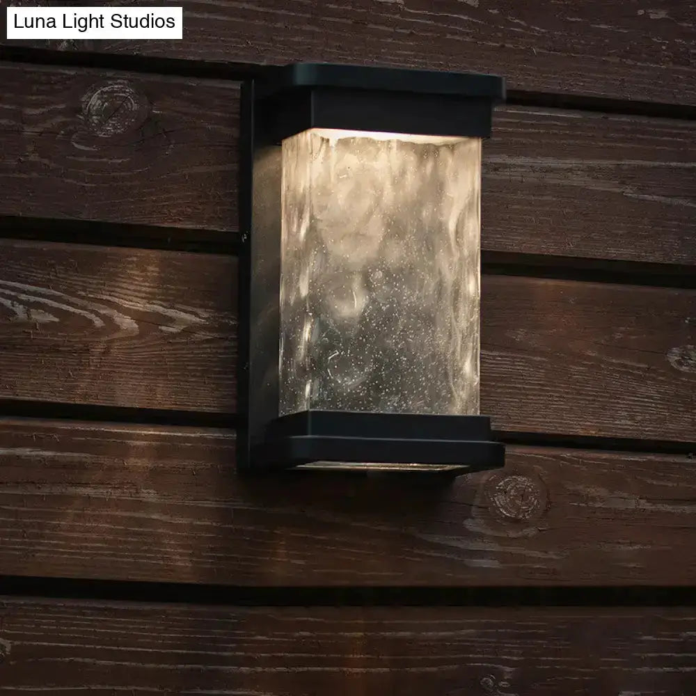Decorbites modern black LED outdoor wall sconce with rippled glass cylinder on Tampa Home & Garden Store