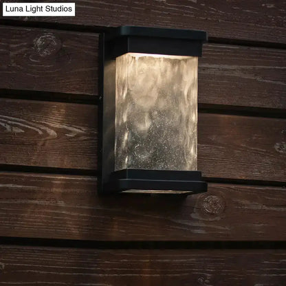 Decorbites modern black LED outdoor wall sconce with rippled glass cylinder on Tampa Home & Garden Store
