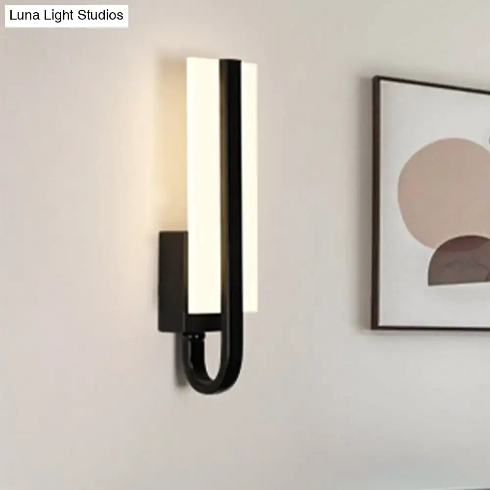 Black LED rectangular wall sconce with vertical light bar and curved U-shaped arm on Tampa Home & Garden Store