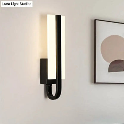 Black LED rectangular wall sconce with vertical light bar and curved U-shaped arm on Tampa Home & Garden Store