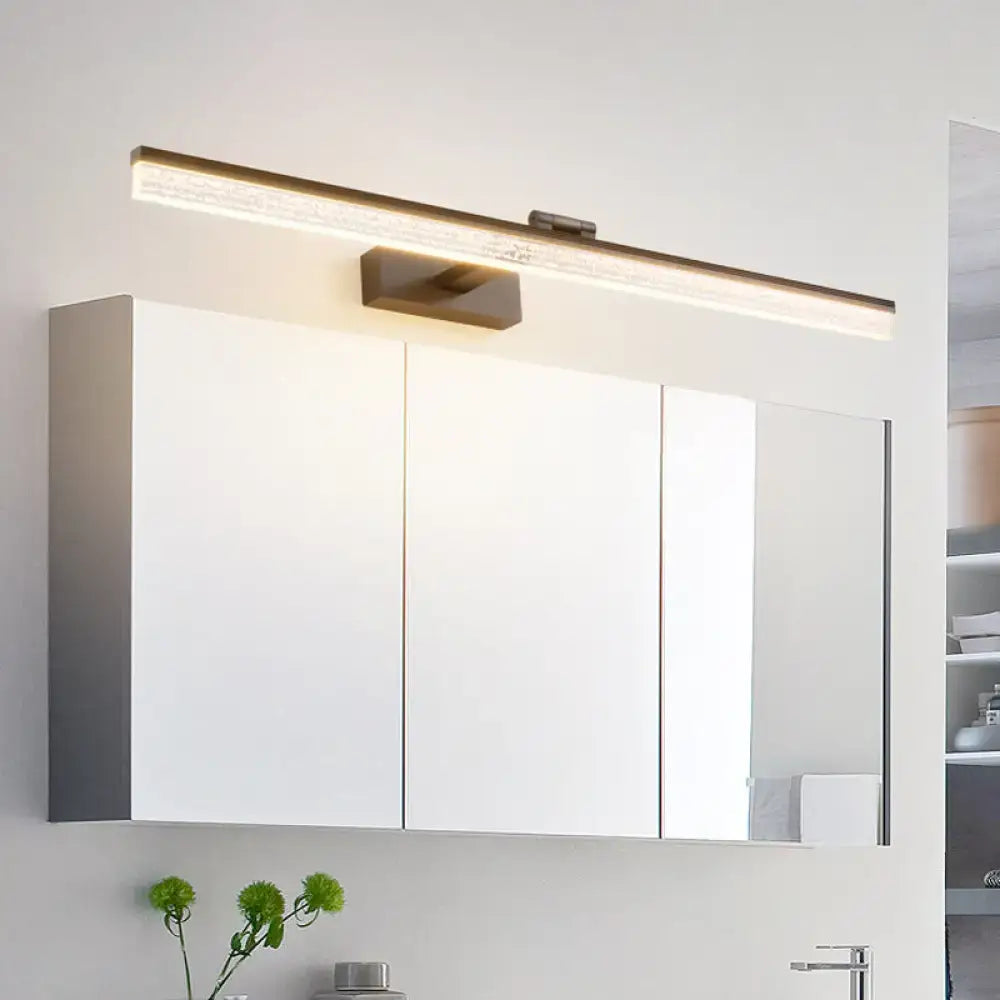 Black frosted vanity light bar above white medicine cabinet in a modern bathroom Decorbites on Tampa Home & Garden Store