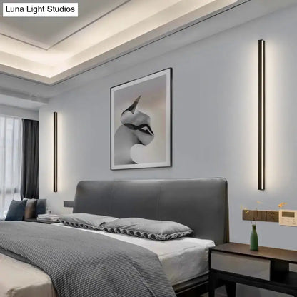 Modern black linear flush mount wall sconces pair flanking a bed in a modern bedroom on Tampa Home & Garden Store