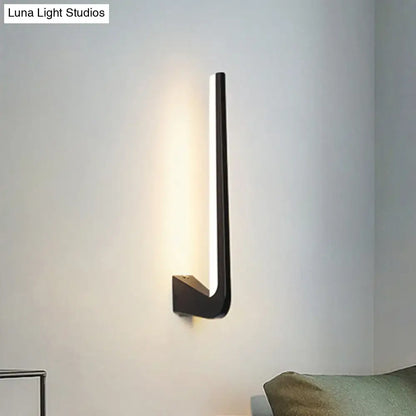 Black direct-wired metal sconce with a slim vertical integrated LED light mounted on wall on Tampa Home & Garden Store