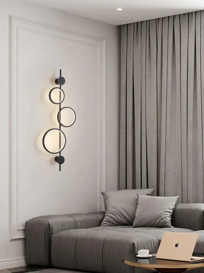 Decorbites black long wall sconce wall light with stacked circular ring lights on wall on Tampa Home & Garden Store