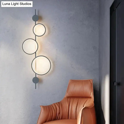 Black long wall sconce with three circular frosted glass shades by Decorbites on Tampa Home & Garden Store