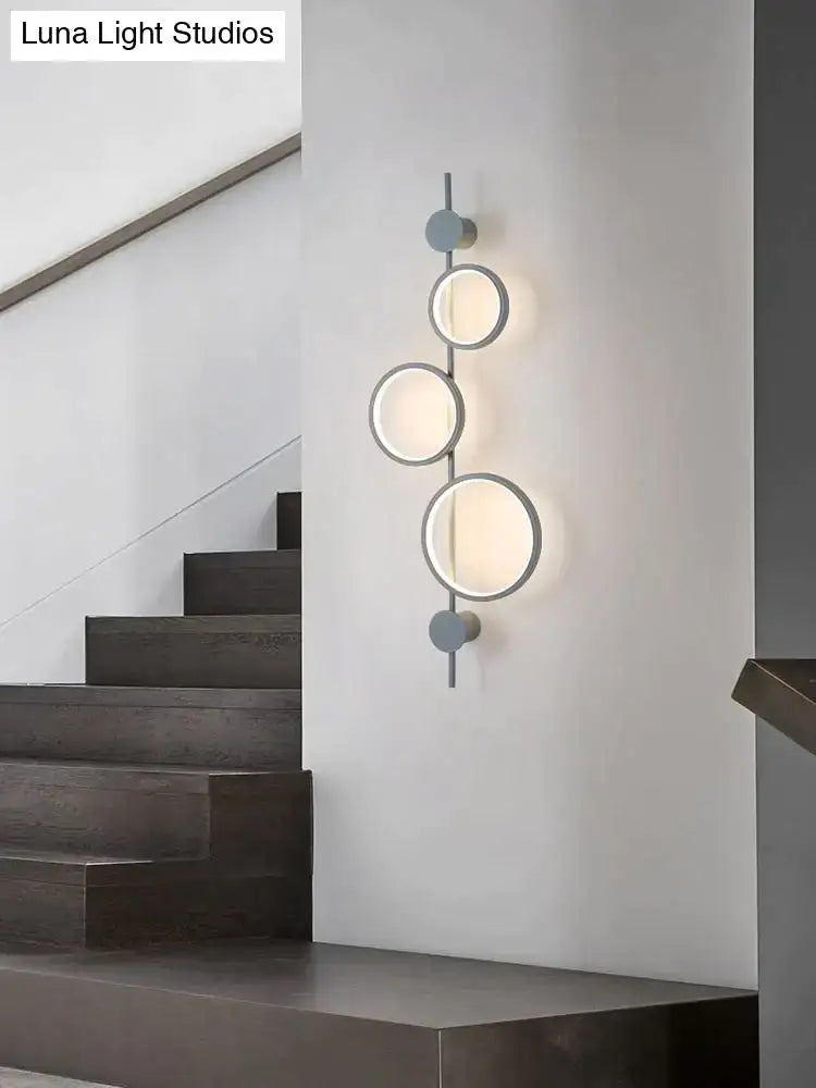 Black long wall sconce by Decorbites featuring three circular rings on a slim vertical bar on Tampa Home & Garden Store