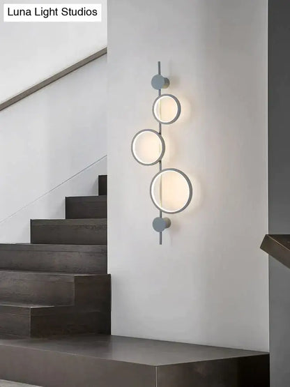 Black long wall sconce by Decorbites featuring three circular rings on a slim vertical bar on Tampa Home & Garden Store