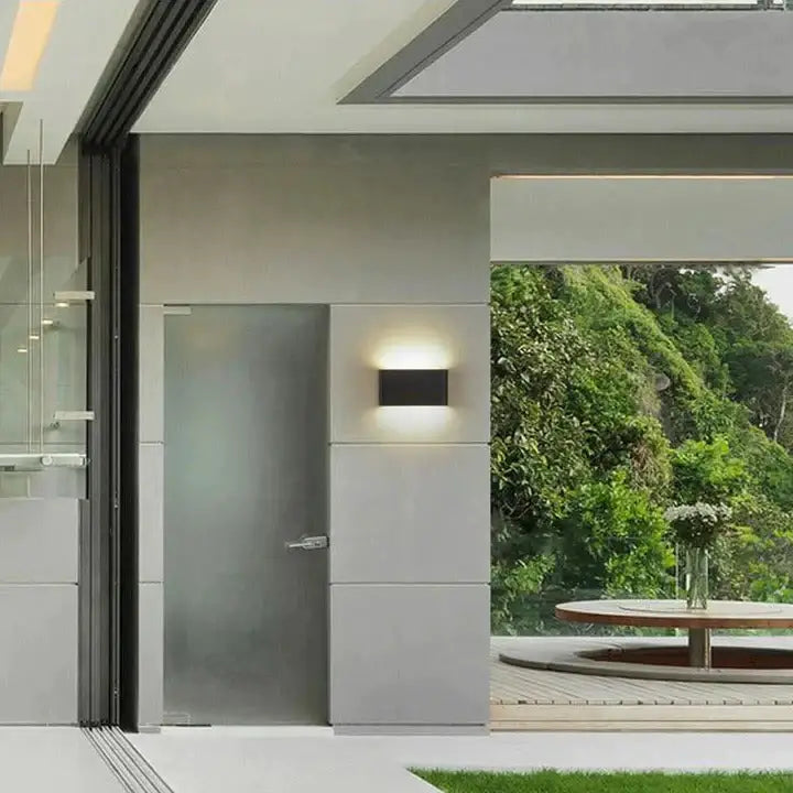 Black Decorbites outdoor wall light, modern rectangular sconce on gray exterior wall on Tampa Home & Garden Store