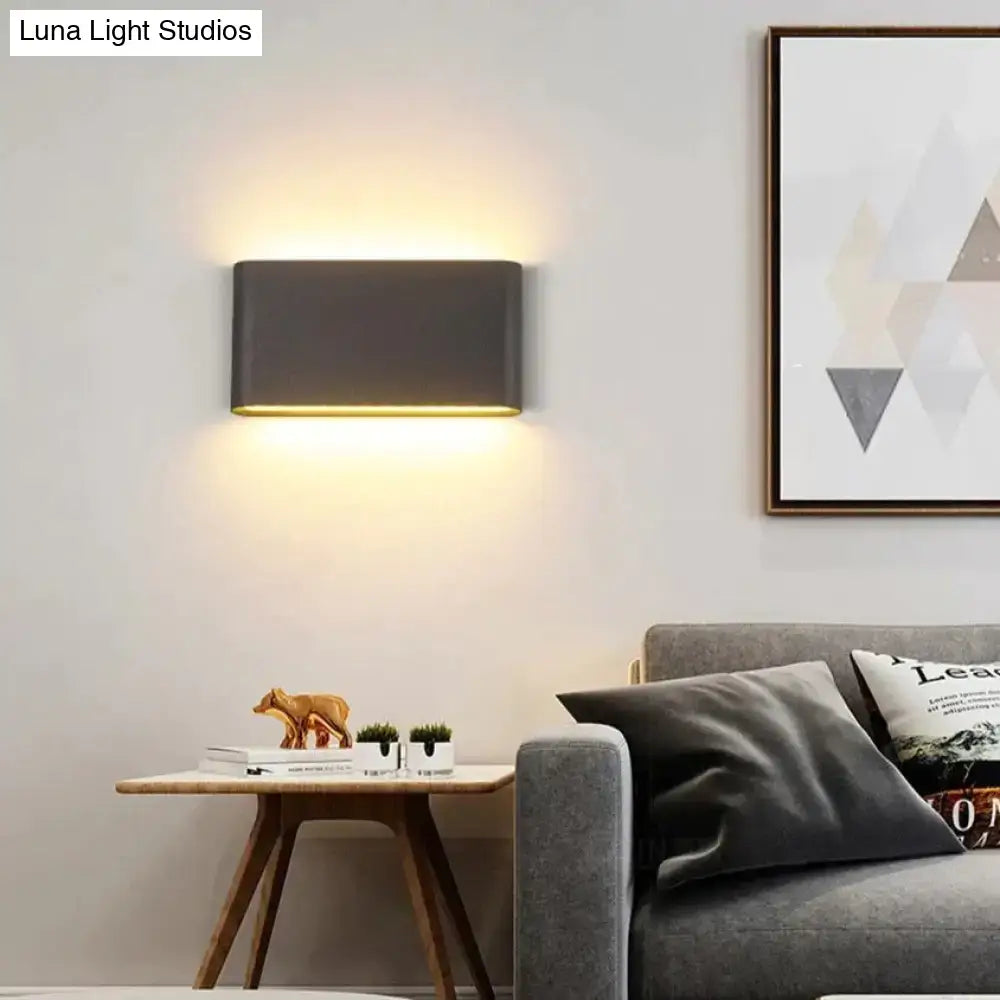 Black outdoor wall light by Decorbites, wall-mounted with warm uplight and downlight on Tampa Home & Garden Store