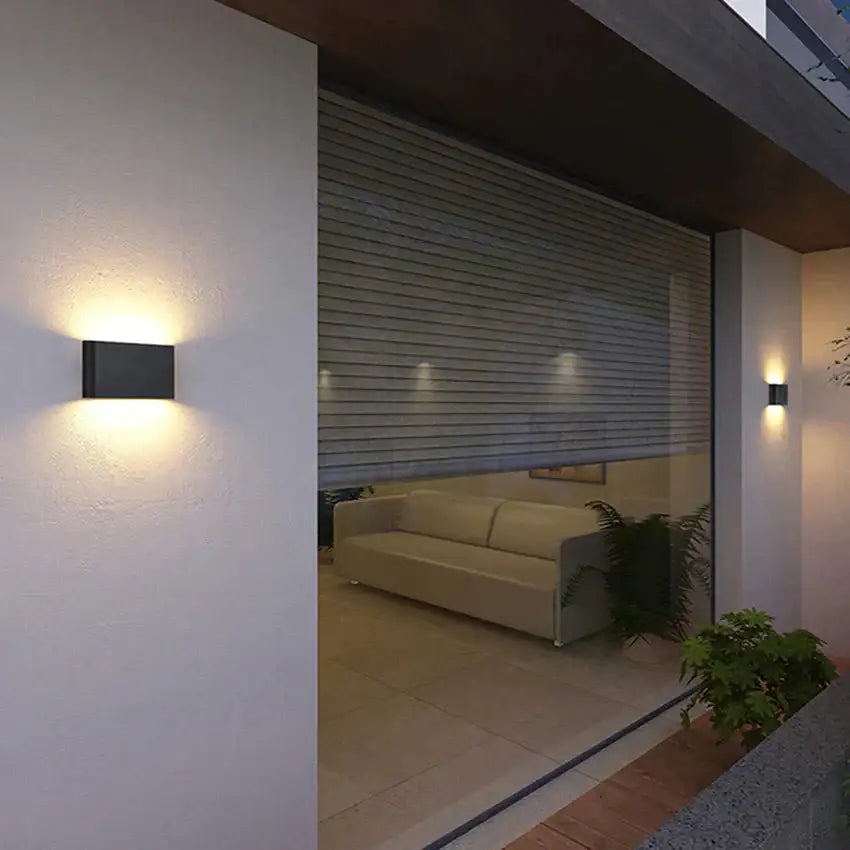Two black Decorbites outdoor wall lights; warm up/down glow by window on Tampa Home & Garden Store