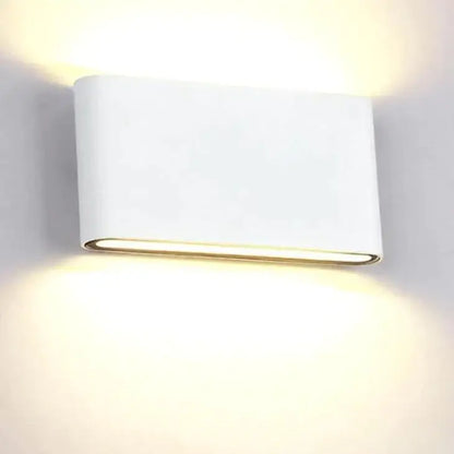 Black outdoor wall light by Decorbites, white housing with gold lip, warm glow on Tampa Home & Garden Store