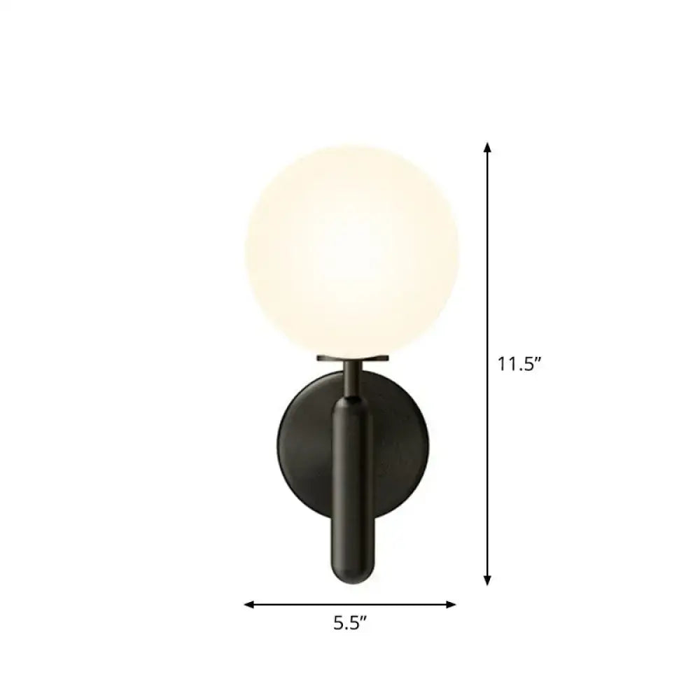 Decorbites black glass globe wall sconce with frosted globe and dark metal backplate on Tampa Home & Garden Store