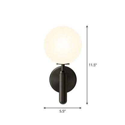 Decorbites black glass globe wall sconce with frosted globe and dark metal backplate on Tampa Home & Garden Store