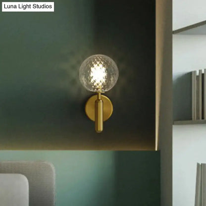 Black Glass Globe Sconce with textured clear globe on brass wall mount on Tampa Home & Garden Store