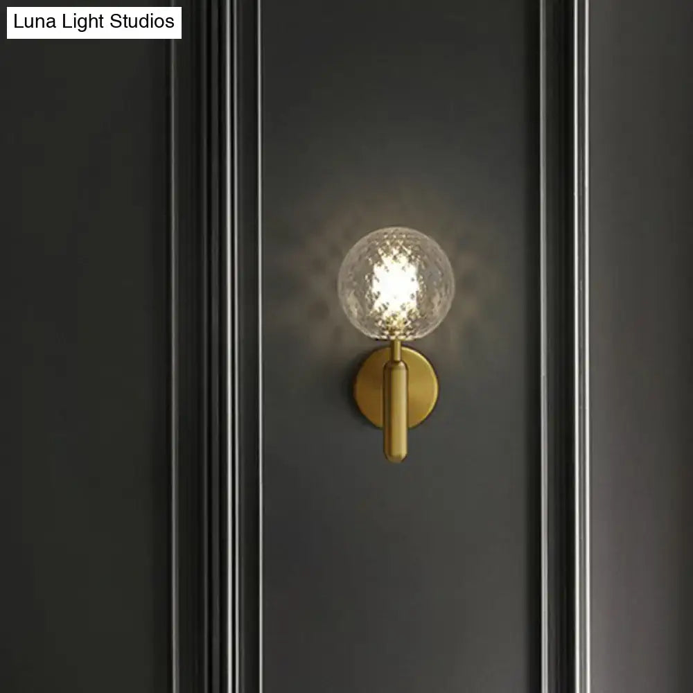 Black glass globe sconce with brass gold wall mount and textured orb by Decorbites on Tampa Home & Garden Store