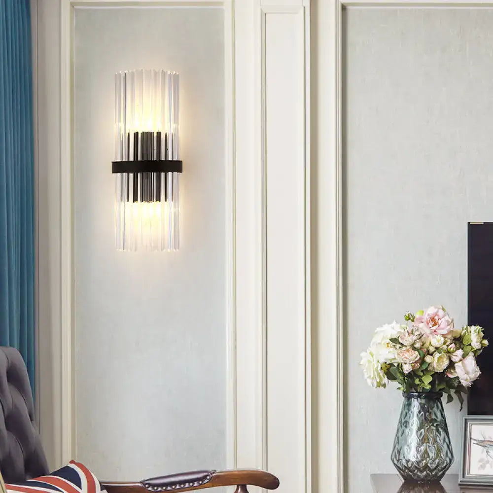 Black crystal wall sconce with clear glass rods and black band, warm dining room lighting on Tampa Home & Garden Store