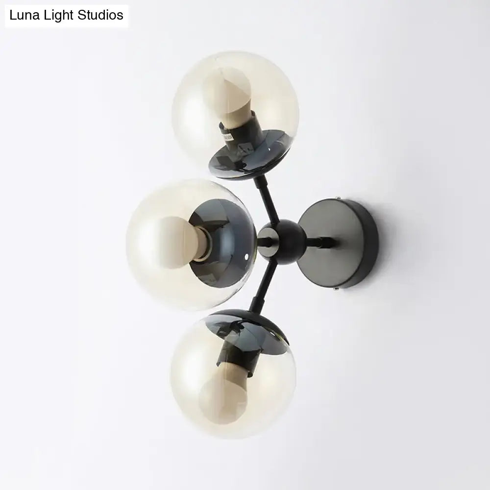 Black glass bathroom sconce by Decorbites with three smoky glass globes on black metal mount on Tampa Home & Garden Store