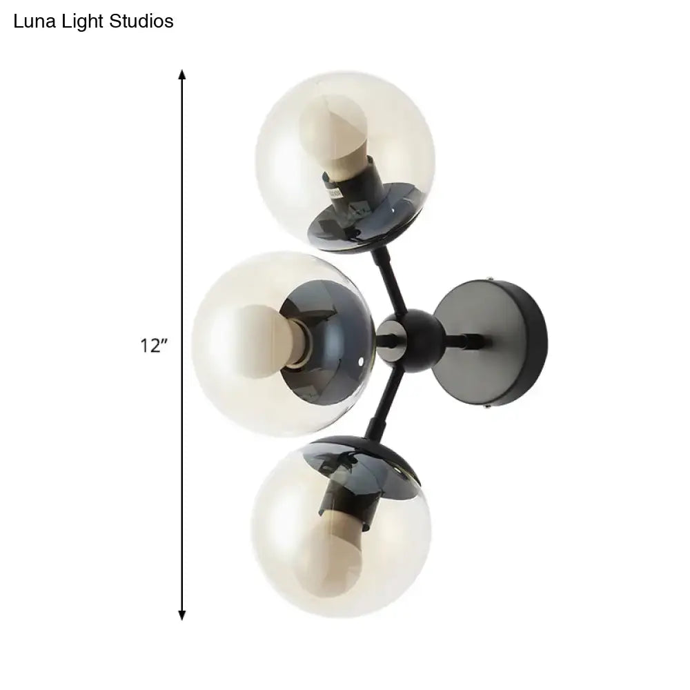 Black glass bathroom sconce with three clear glass globes on a black metal mount on Tampa Home & Garden Store