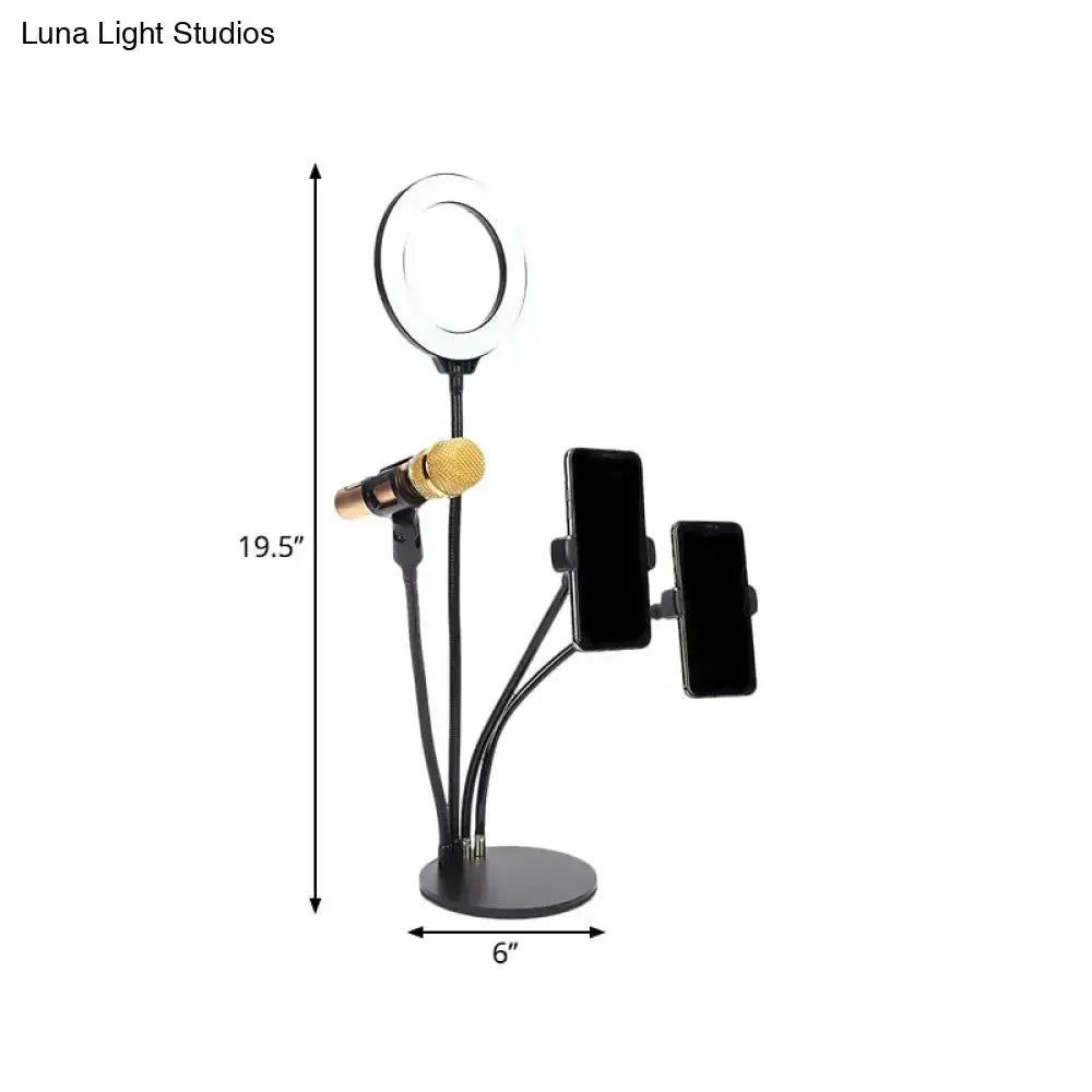 Modern black metal LED circle mirror on a multi-arm bedroom stand with two phone mounts on Tampa Home & Garden Store