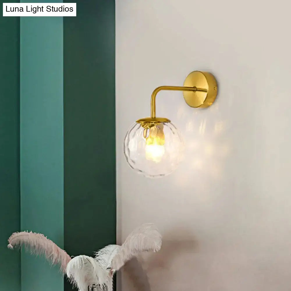 Black Metal Rippled Sconce by Decorbites; wall-mounted with gold curved arm and glass globe on Tampa Home & Garden Store