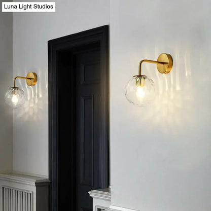 Black Metal Rippled Sconce pair with gold-tone arms and clear ribbed glass globes on wall on Tampa Home & Garden Store
