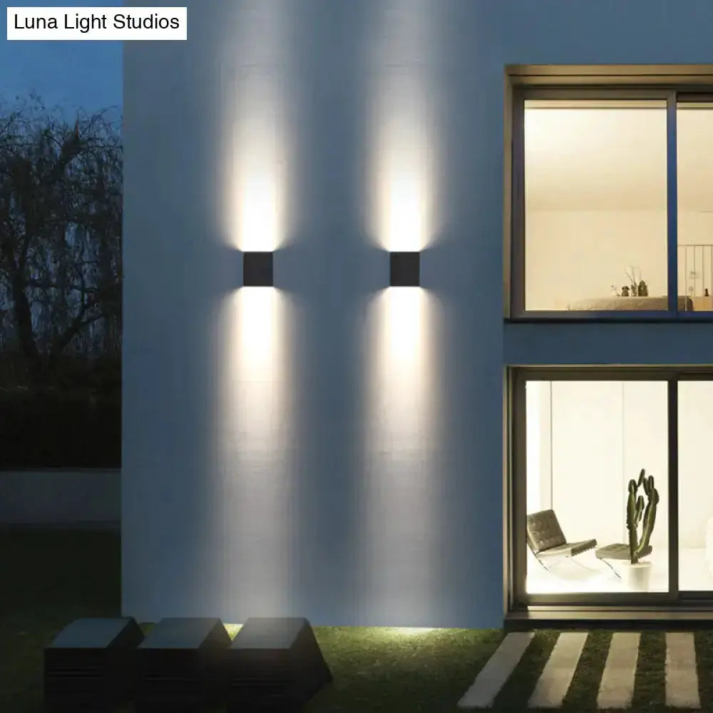 Modern black metal outdoor wall light sconce with dual up/down glow, pair on white wall on Tampa Home & Garden Store