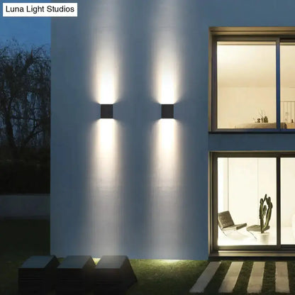 Modern black metal outdoor wall light sconce with dual up/down glow, pair on white wall on Tampa Home & Garden Store