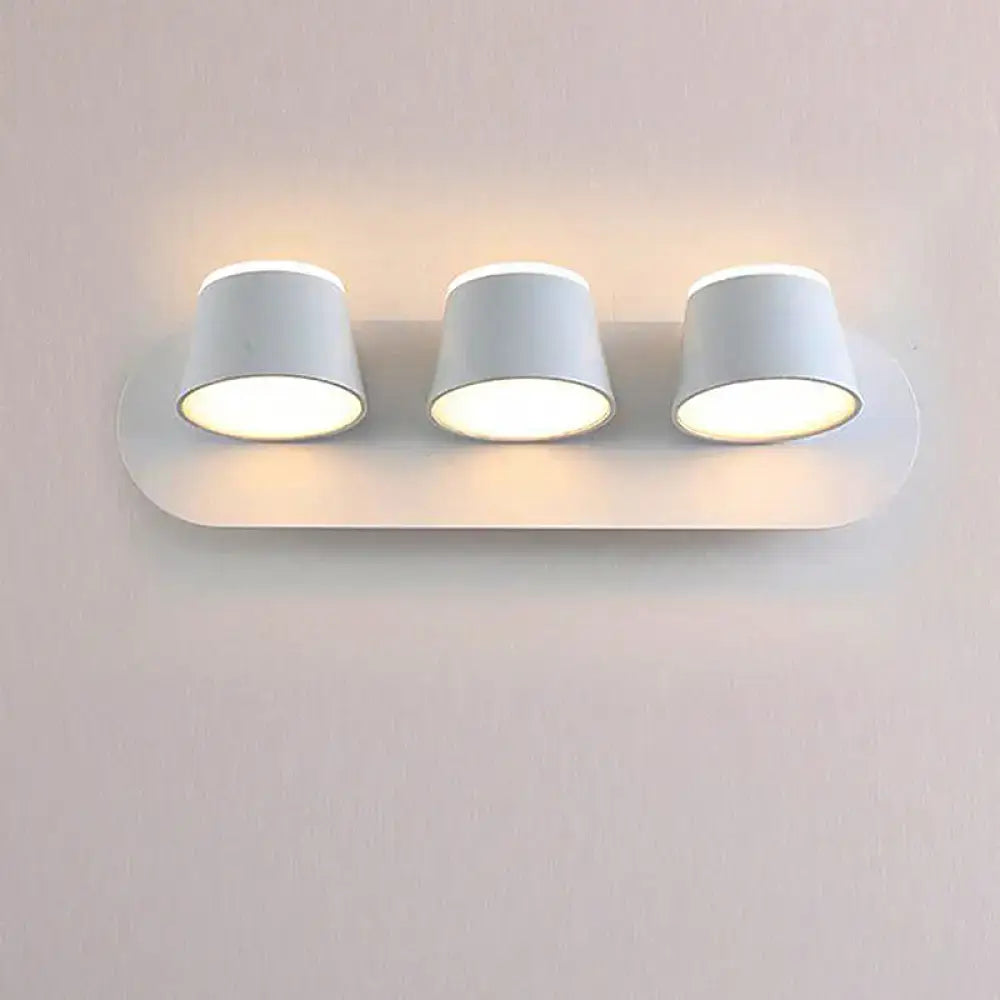Metal cone-shade 1-3 light wall sconce with three white cones on curved backplate on Tampa Home & Garden Store