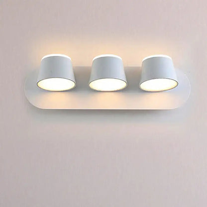Metal cone-shade 1-3 light wall sconce with three white cones on curved backplate on Tampa Home & Garden Store