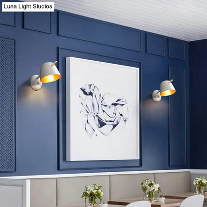 Decorbites black metal wall light pair with white shades on navy paneling on Tampa Home & Garden Store