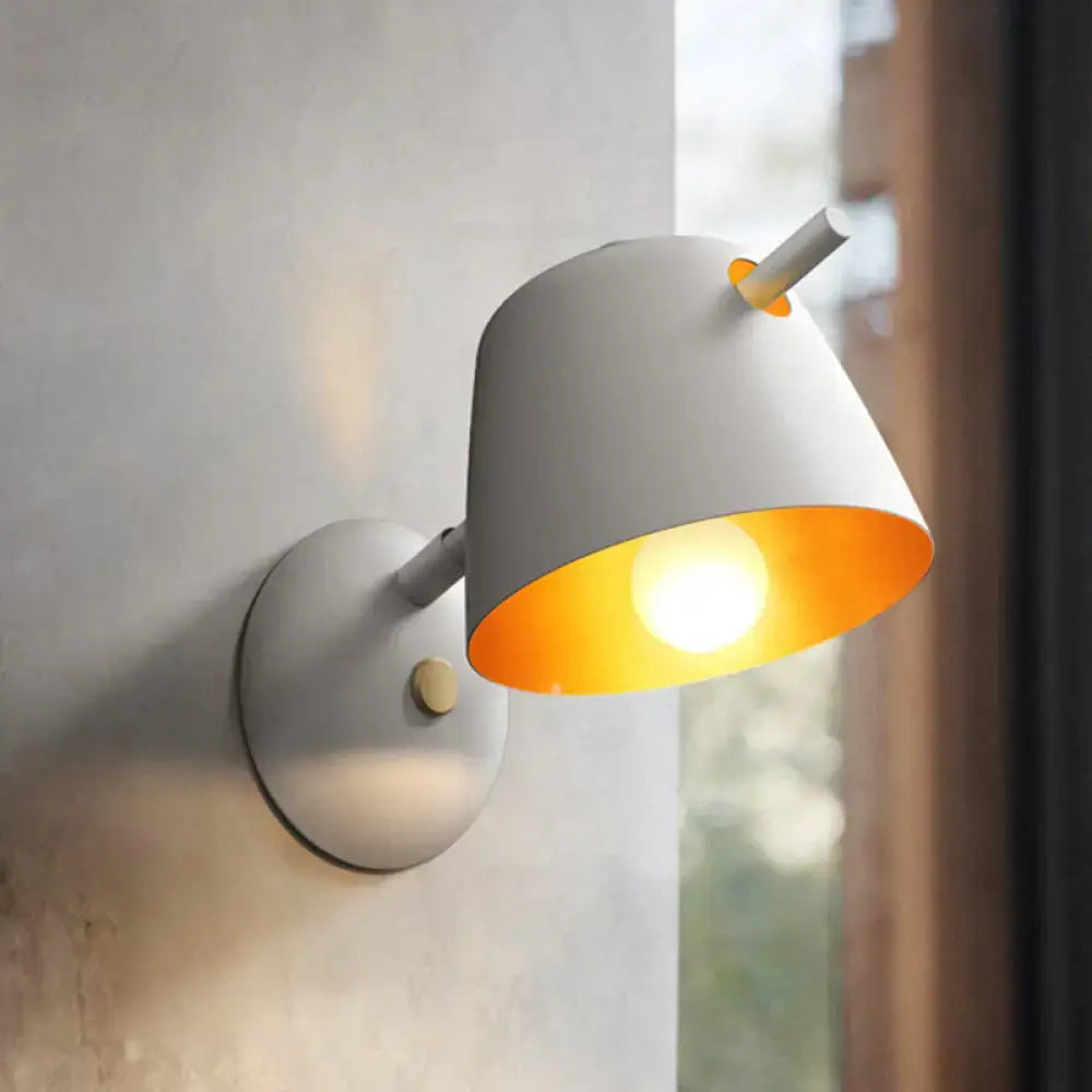 Black metal wall light by Decorbites, conical white shade, warm bulb glow on Tampa Home & Garden Store