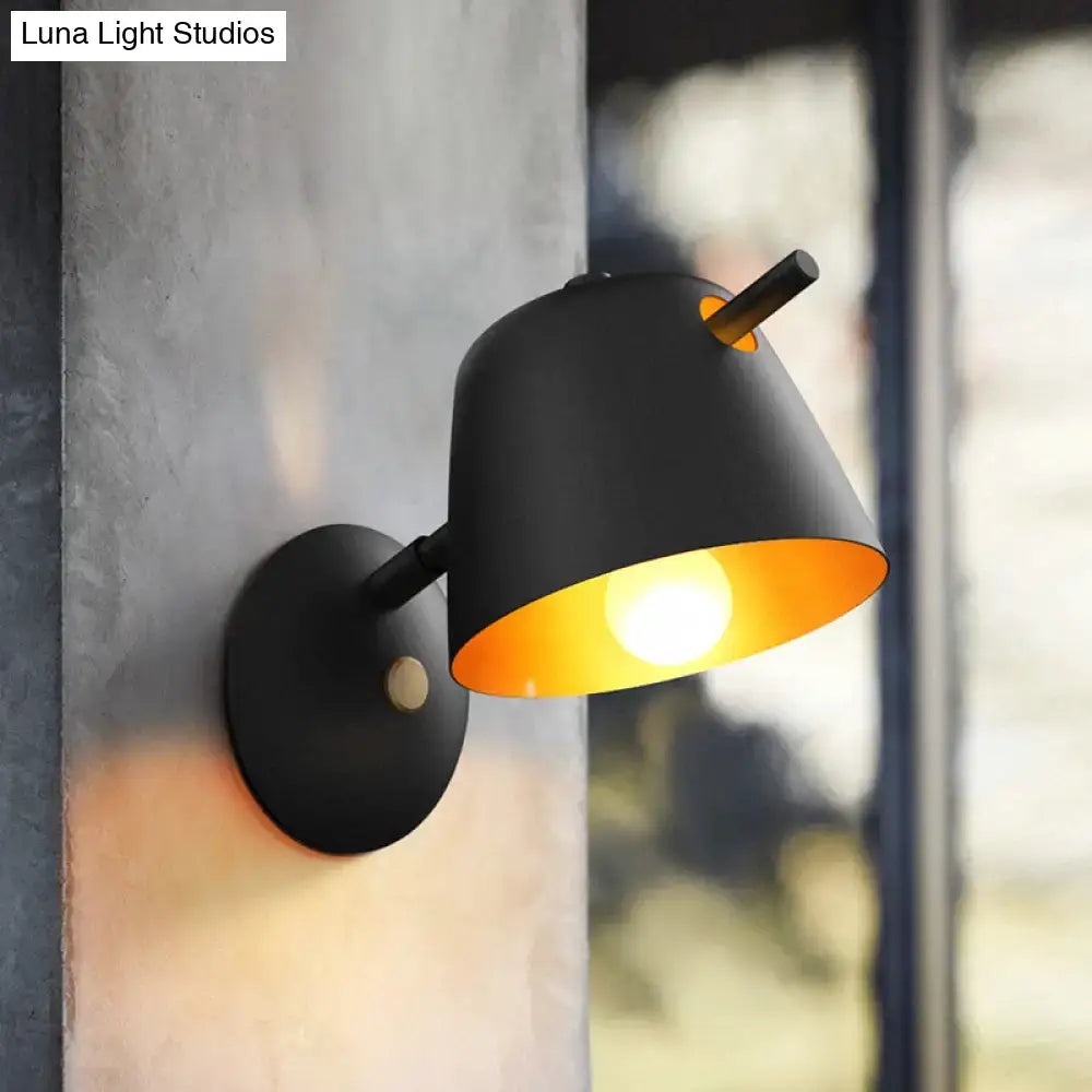 Black metal wall light sconce by Decorbites with downward conical shade and warm amber interior on Tampa Home & Garden Store