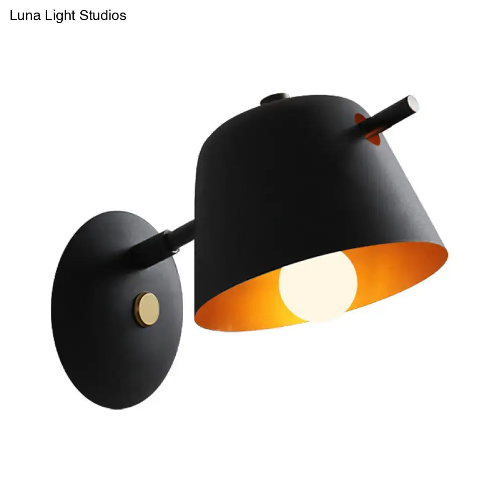 Black metal wall light with conical shade and warm orange interior by Decorbites on Tampa Home & Garden Store