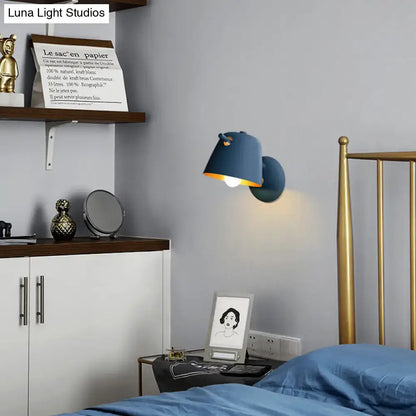 Black Metal Wall Light by Decorbites; blue wall lamp with yellow interior near bed on Tampa Home & Garden Store