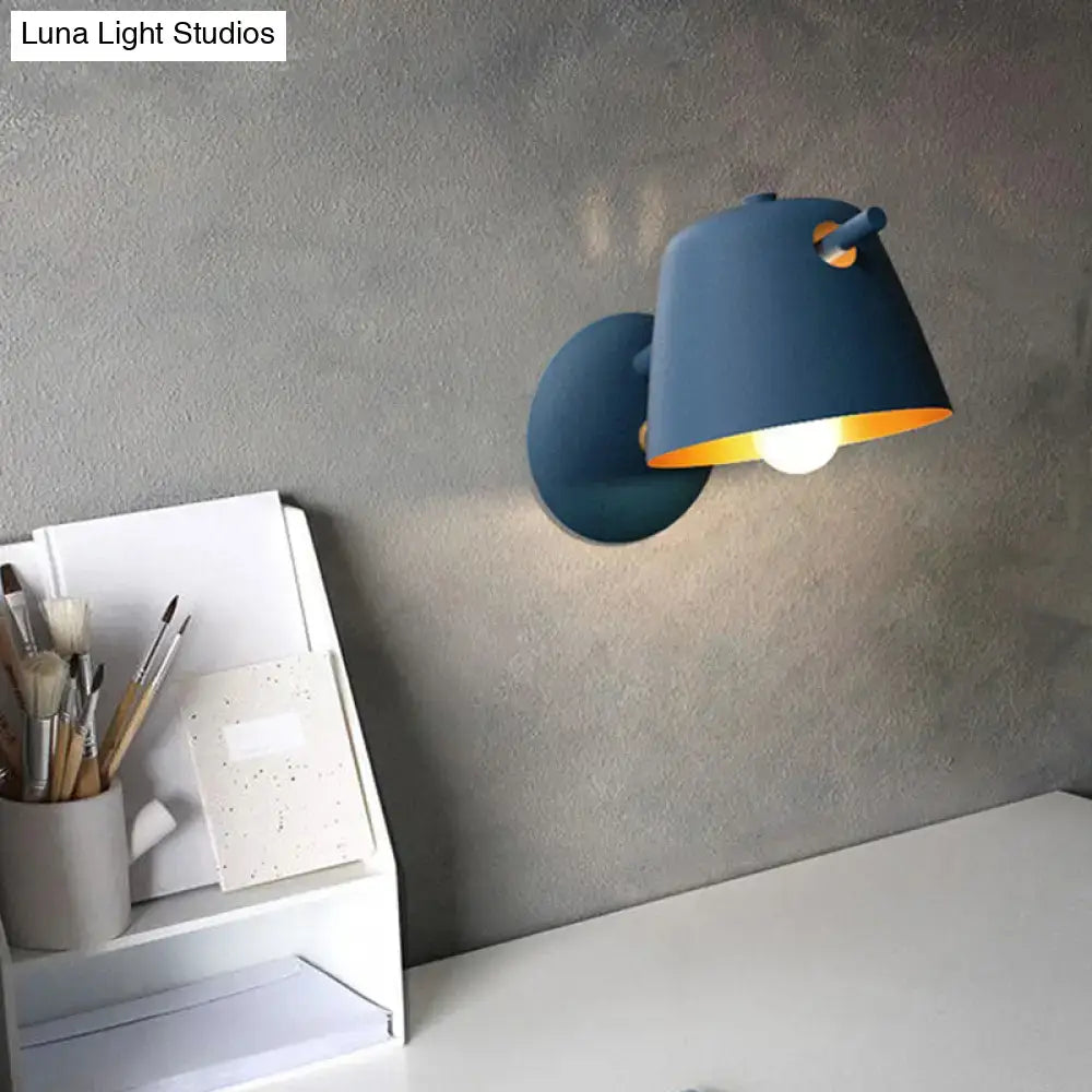 Black metal wall light by Decorbites with blue shade and warm glow on Tampa Home & Garden Store