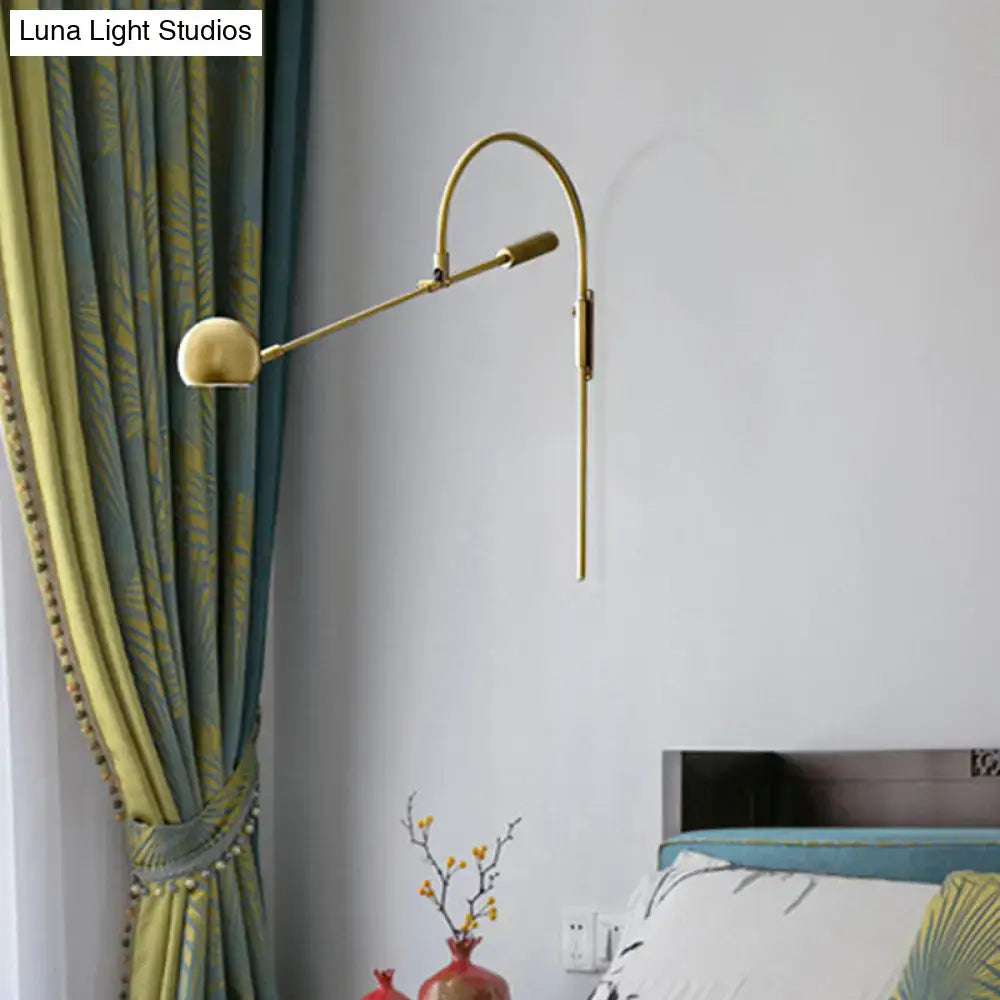 Black metal sphere sconce with brass-tone curved arm and wall mount for modern lighting on Tampa Home & Garden Store