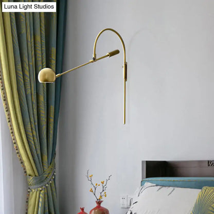 Black metal sphere sconce with brass-tone curved arm and wall mount for modern lighting on Tampa Home & Garden Store