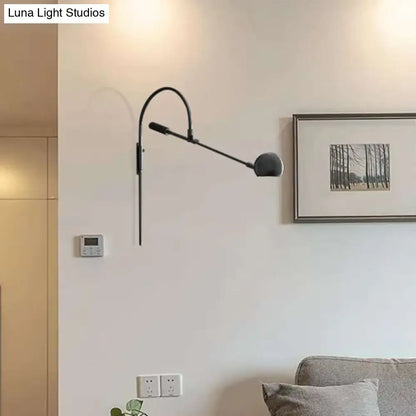 Black metal sphere sconce with adjustable arm, wall-mounted for modern living spaces on Tampa Home & Garden Store