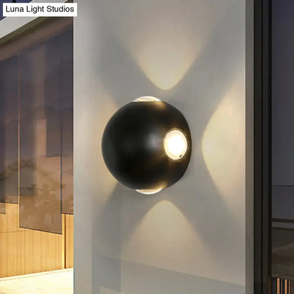 Black spherical outdoor wall sconce by Decorbites, wall-mounted with warm glow on Tampa Home & Garden Store