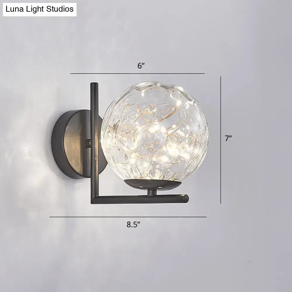 Black globe wall sconce with glass orb and black metal mount by Decorbites on Tampa Home & Garden Store