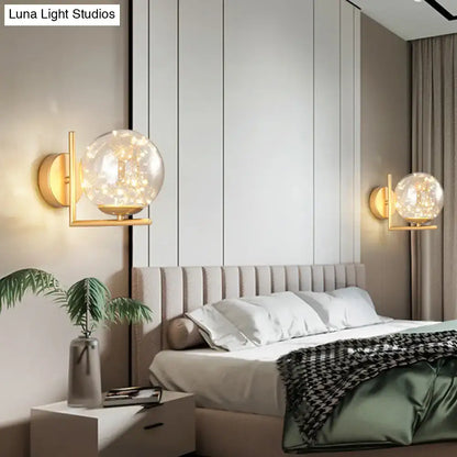 Black Globe Wall Sconce pair by Decorbites with brass finish in a modern bedroom on Tampa Home & Garden Store