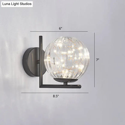 Black globe wall sconce with clear glass orb and warm LED lights Decorbites on Tampa Home & Garden Store