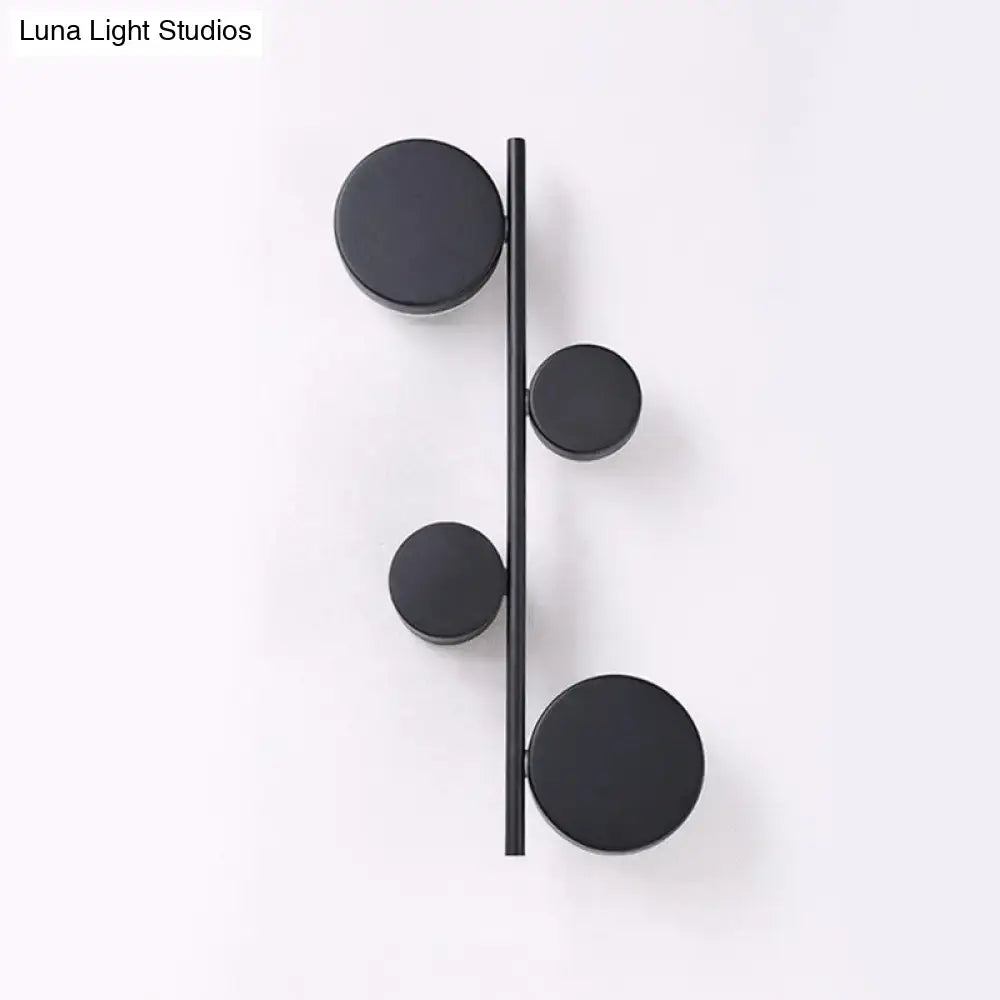 Black Circle Wall Sconce by Decorbites featuring four round discs along a slim vertical bar on Tampa Home & Garden Store
