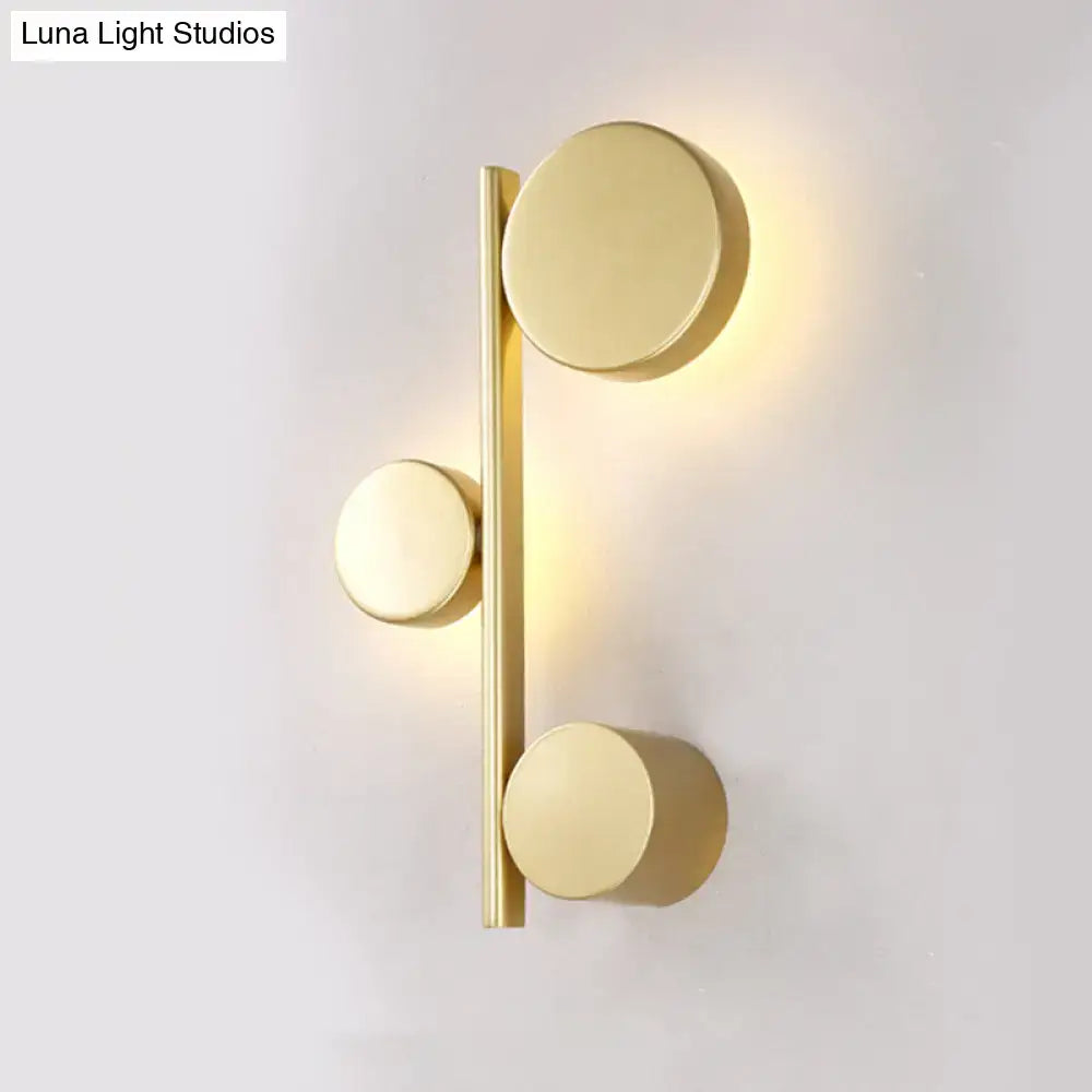 Decorbites circle metal wall sconce with brass finish and three discs on vertical bar on Tampa Home & Garden Store