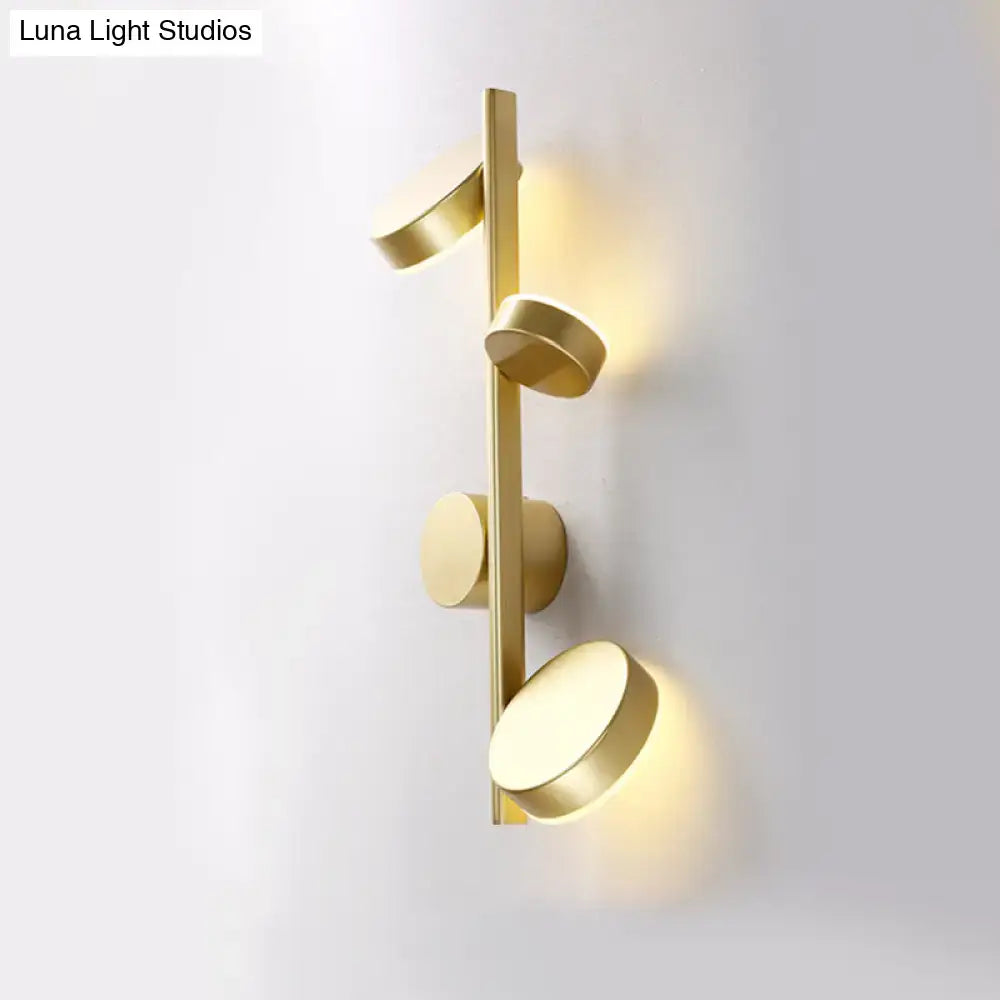 Black Circle Wall Sconce by Decorbites, gold-tone bar with round disks and warm glow on Tampa Home & Garden Store