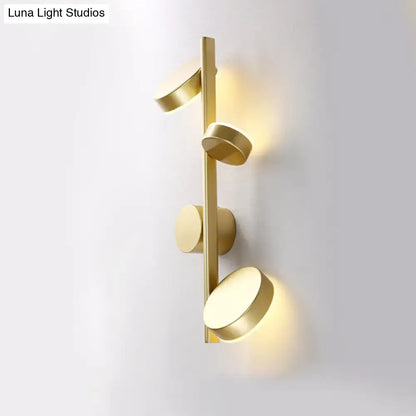Black Circle Wall Sconce by Decorbites, gold-tone bar with round disks and warm glow on Tampa Home & Garden Store