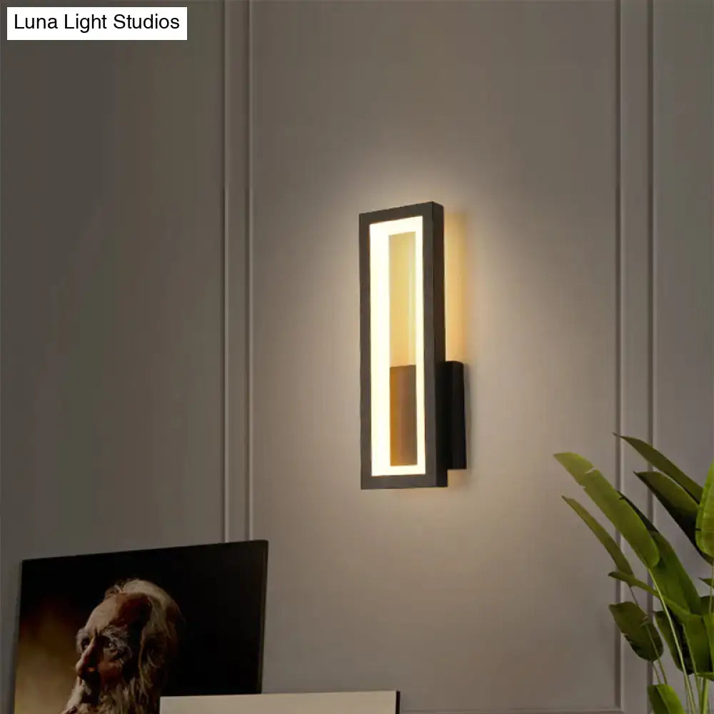 Modern black minimalist LED wall sconce with rectangular frame and warm white light on Tampa Home & Garden Store