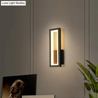 Modern black minimalist LED wall sconce with rectangular frame and warm white light on Tampa Home & Garden Store